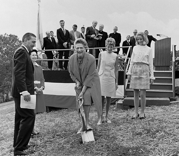 Catherine Filene Shouse digs a ceremonial shovel at Wolf Trap's groundbreaking.