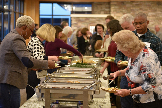 Volunteers help themselves to a delicious buffet dinner.