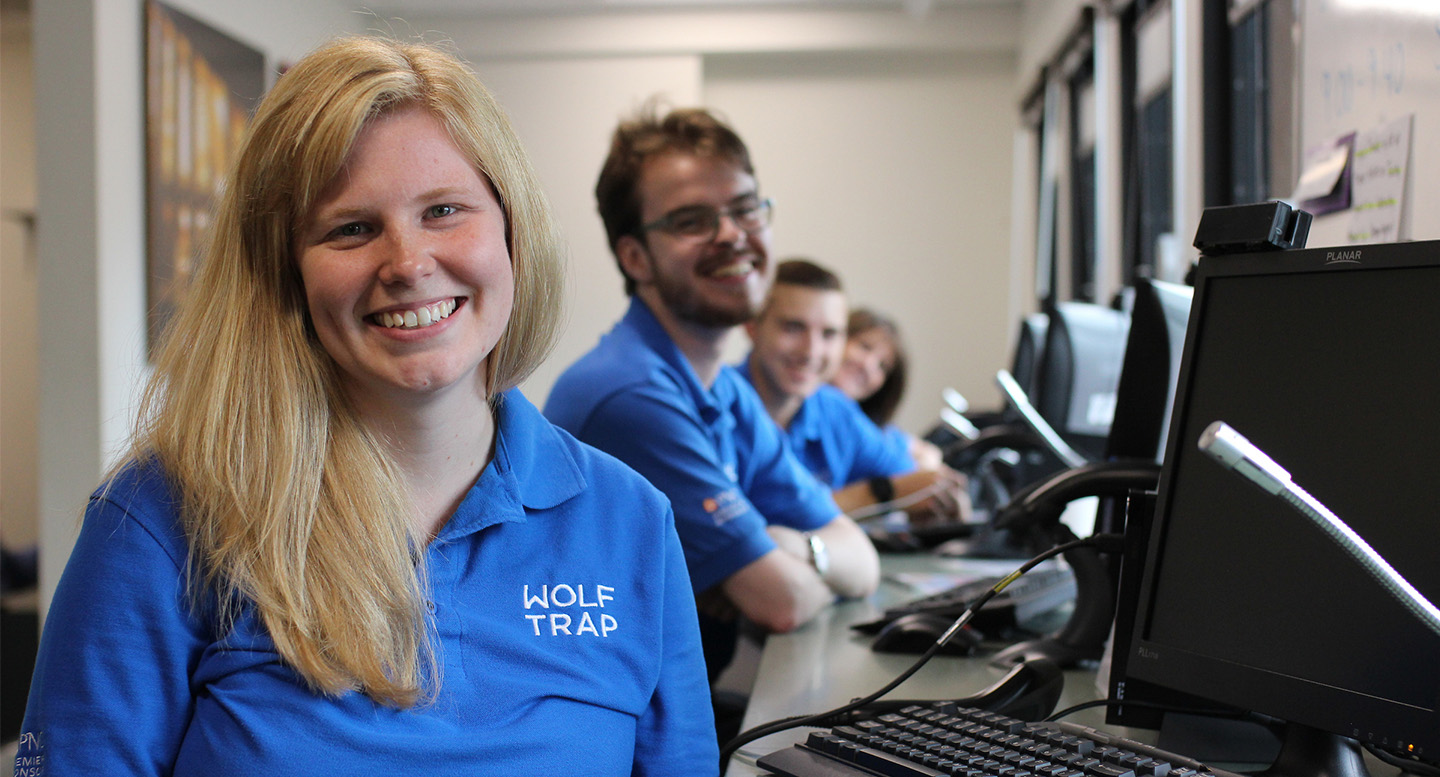 Wolf Trap box office staff smile from the box office windows.