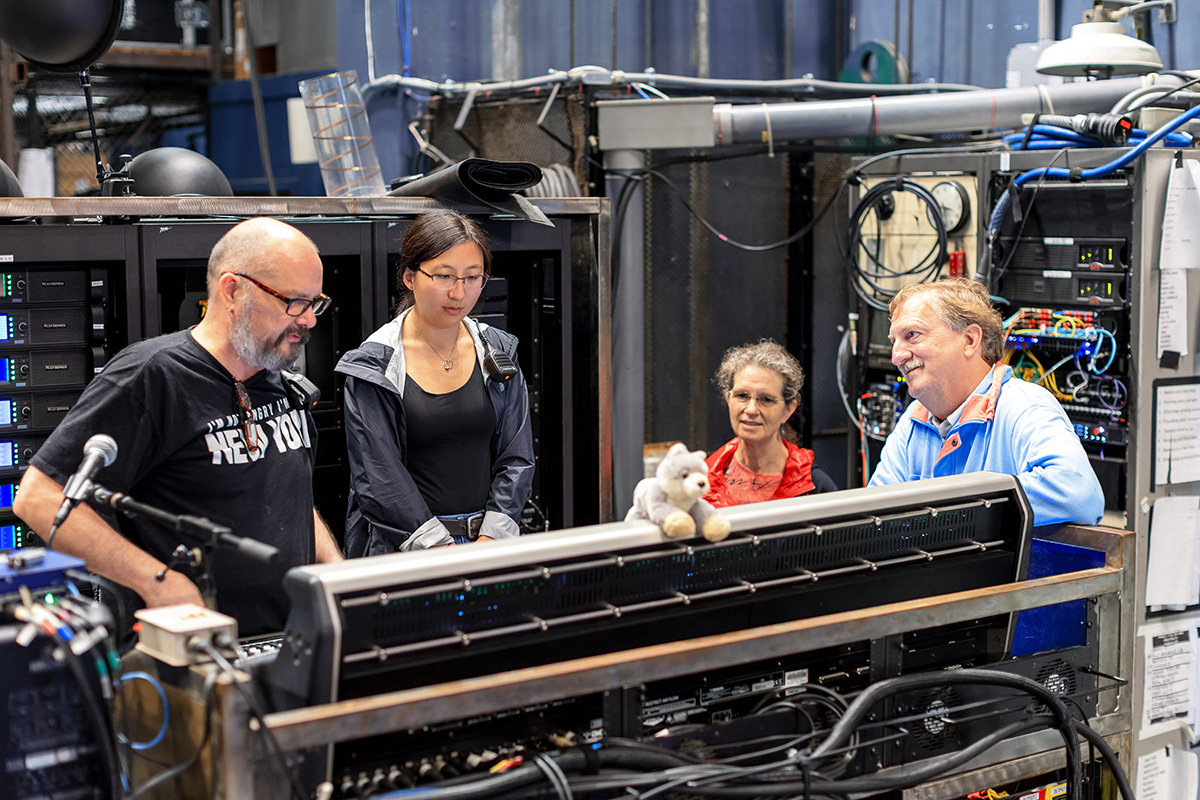 Stagehands show members how to work sound and lights at the Filene Center.