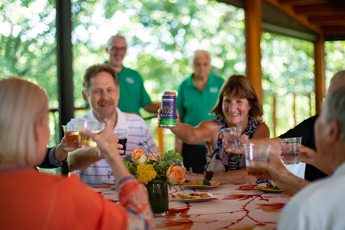 Members raise their glasses at a member dinner event.