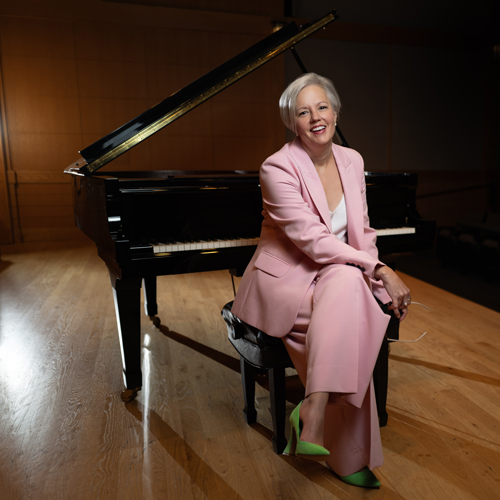 Lee Anne Myslewski sitting at a grand piano.