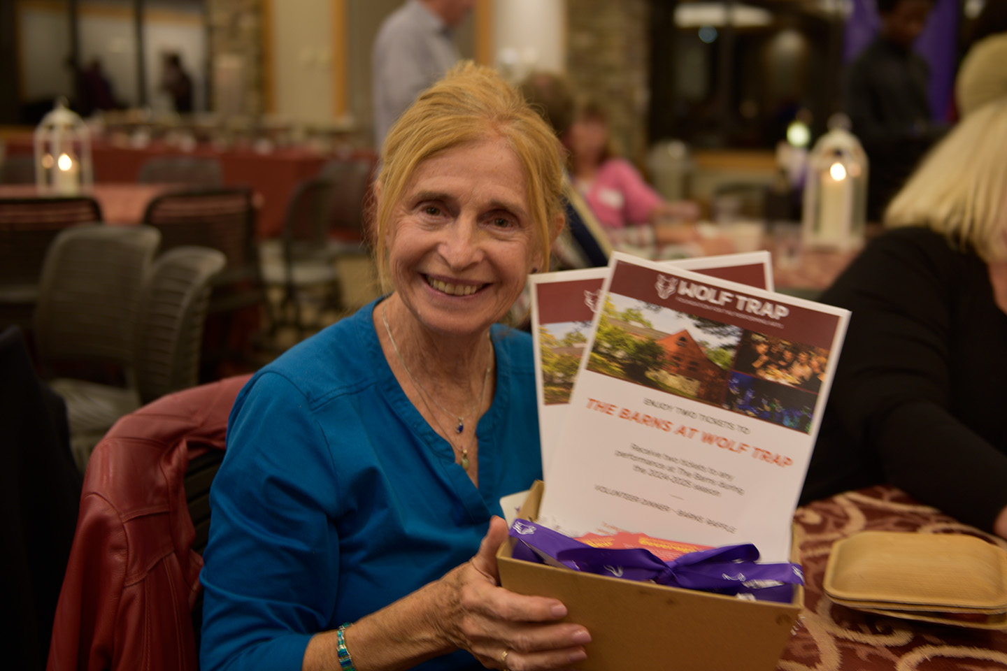 Volunteer raffle winner shows off her prize.