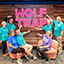 Wolf Trap volunteers pose with a neon Wolf Trap sign.