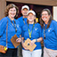 Four volunteers at the gift shop holding clipboards.