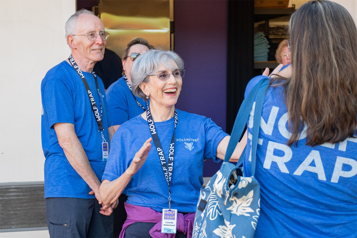 Wolf Trap volunteers smiling outside the chair rental area.