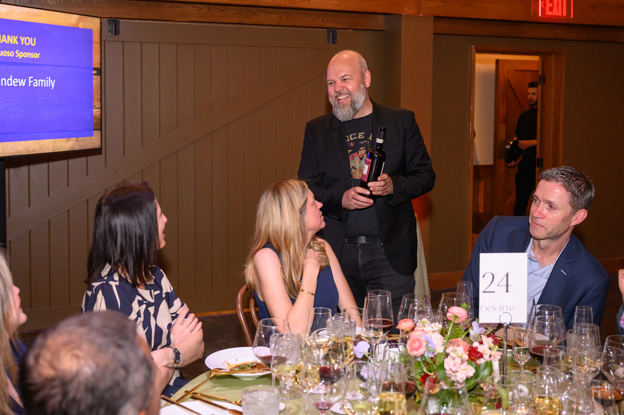 Master Sommelier Justin Moore visiting tables to share wine knowledge.