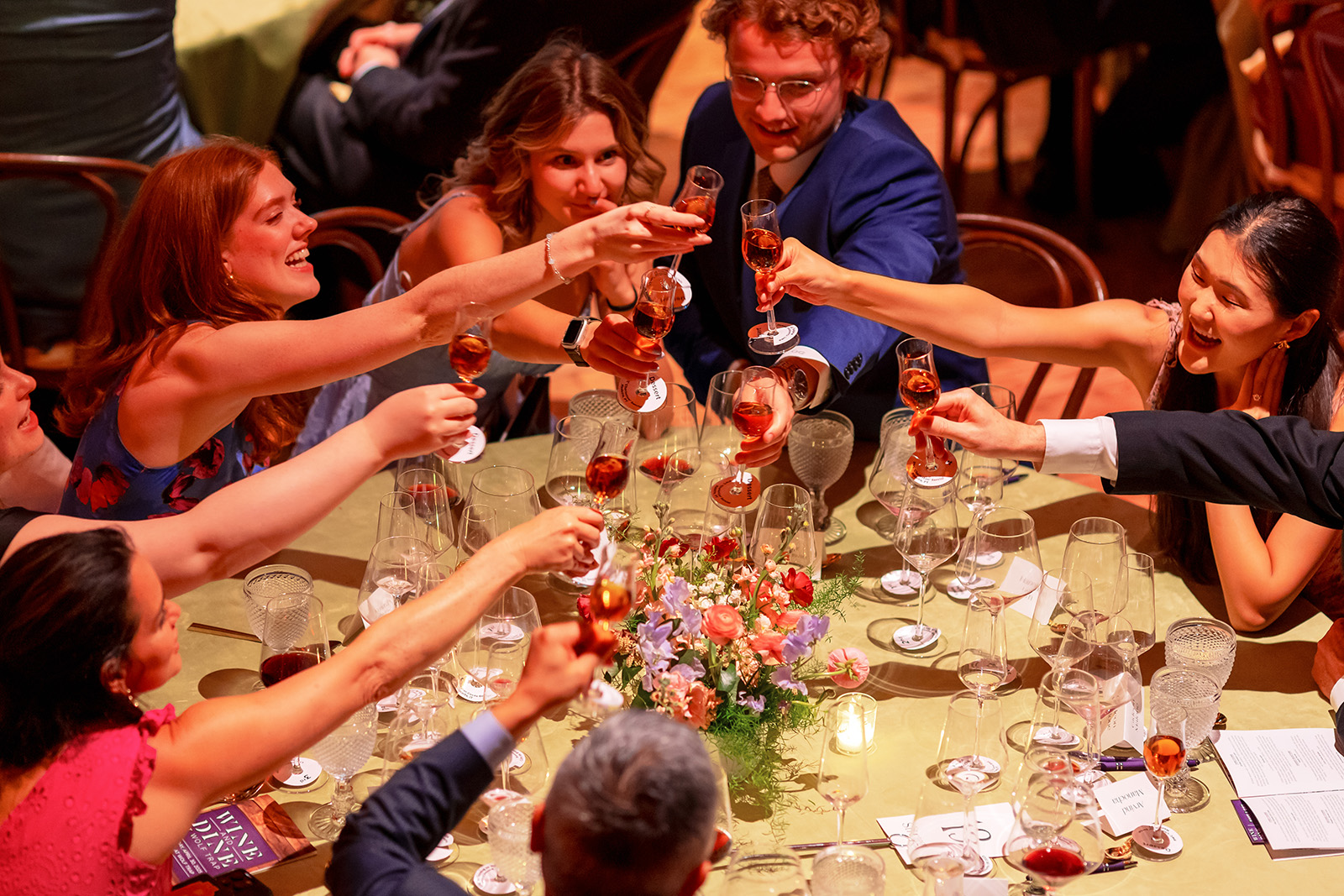 Dinner guests raise their glasses in a toast.