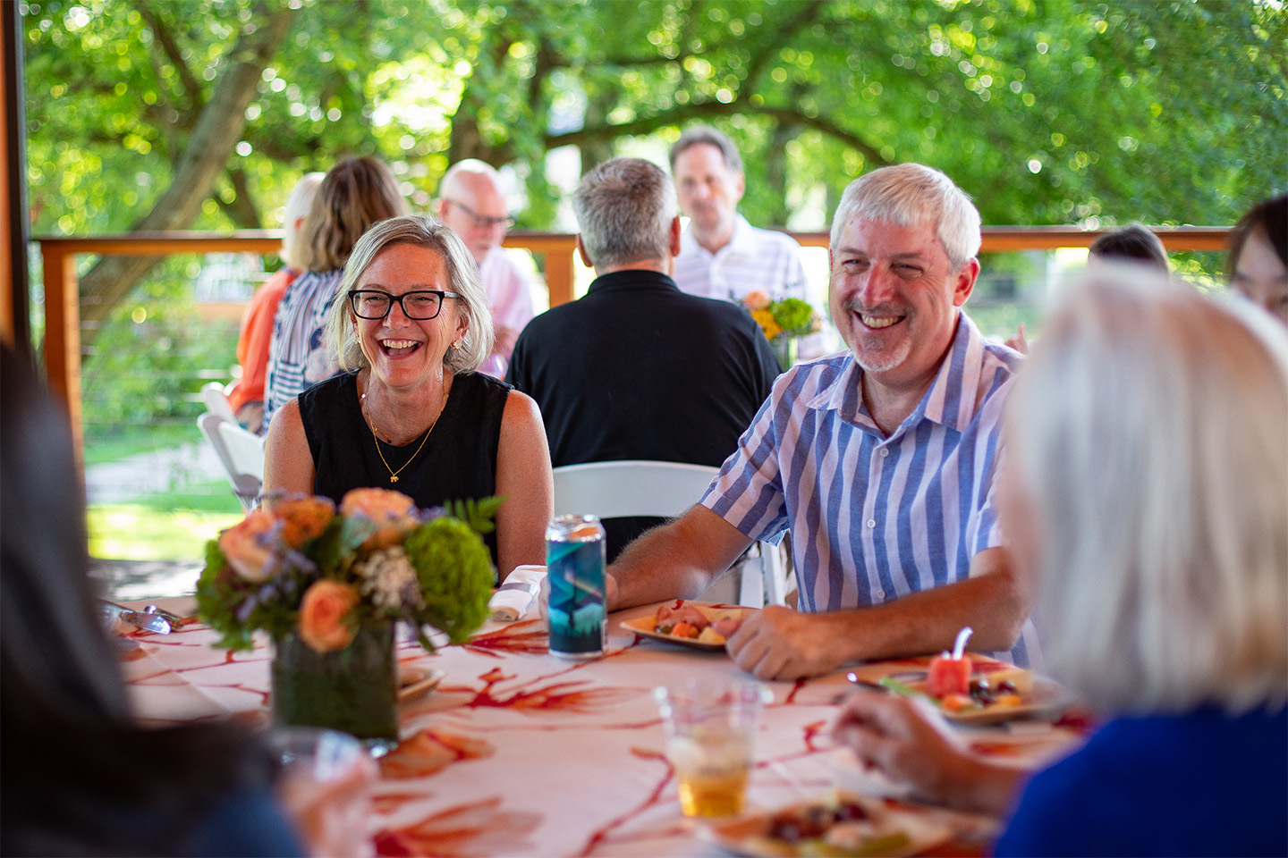 Members laughing at a member dinner at the pavilion.