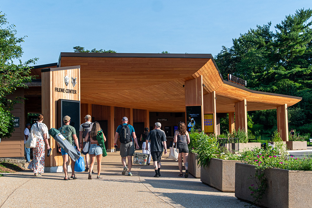 Concert patrons carrying coolers walk through Wolf Trap's new main gate.
