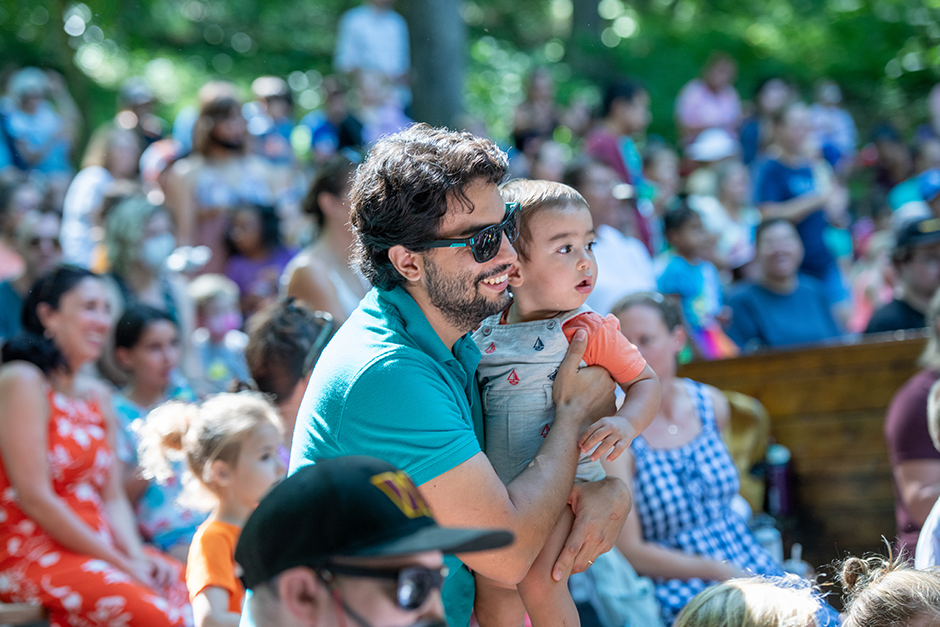Father and child at a Children's Theatre-In-The-Woods show.
